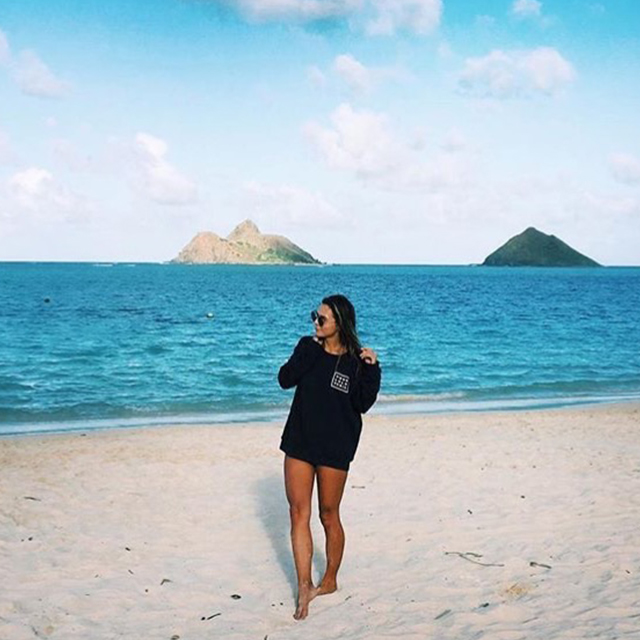 Model walking with HP crewneck in Kailua